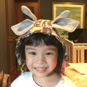 Young kid wearing a hood with giraffe ears