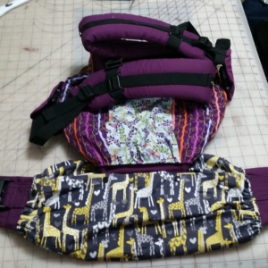 Giraffe Print Ninja Roll Carrier keeper being worn on a Lillebaby Complete baby Carrier.