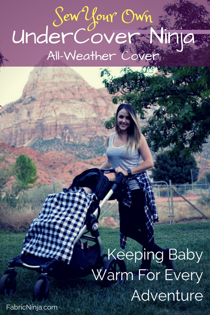 A mom pushing a stroller with mountain in the background. Stroller has a smiling baby with black and white checked cover pulled up to the chin. Sew your own UnderCover Ninja. All weather cover. Keeping Baby warm for every adventure. 