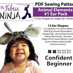 A toddler smiling big while wearing a giraffe hood. Animal elements Ear Pack. 13 ear shapes PDF sewing Pattern. Confident Beginner.