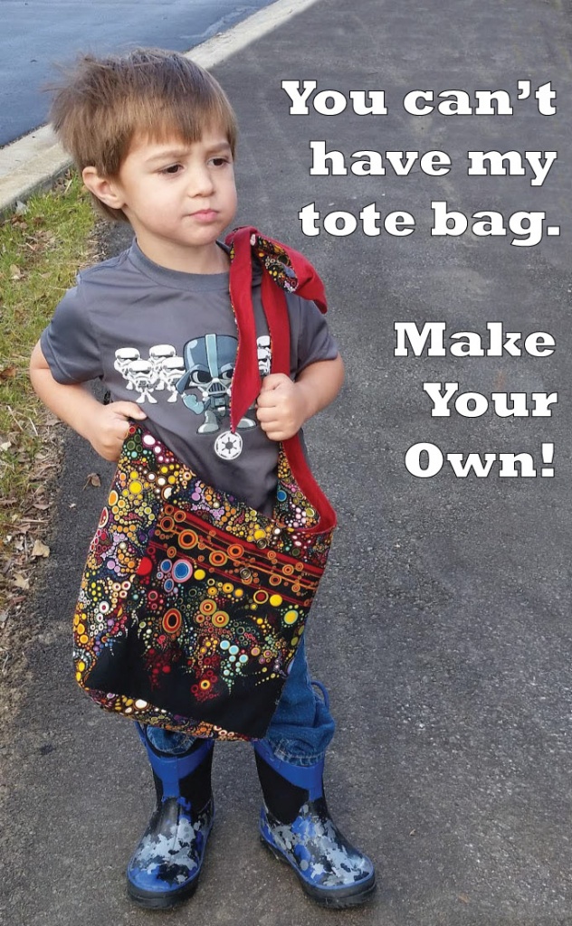 Little boy with smug look on his face wearing a tote bag. You can't have my tote bag Make your own! 