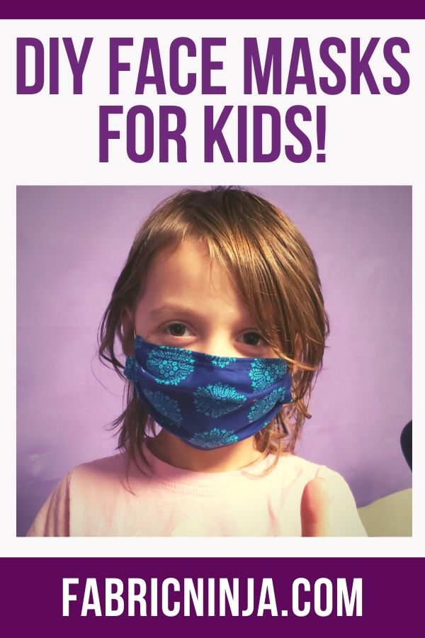 Young girl dressed in pink wearing a blue mask