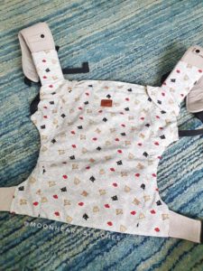 Happy baby carrier with light colored slipcover
