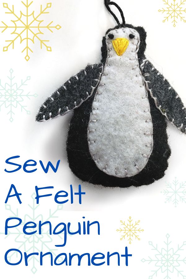 Sew a felt Penguin Ornament - Black and white felt penguin with blue snowflakes around it. 