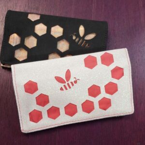 small business card wallets with bee design cut into the outer material