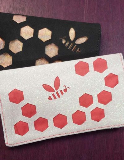 small business card wallets with bee design cut into the outer material