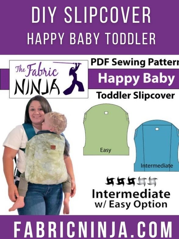 white woman with dark hair wearing blond haired baby in a happy baby toddler carrier with a green tie-dye slipcover