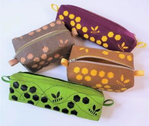 4 box pouches with bee themed motifs