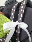 closeup of tie strap hood. A white bow tied around the strap