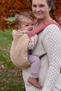 cream linen slipcover on pink onbuhimo carrier with ligh skinned baby and mother.