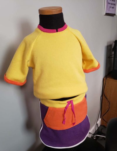 Yellow sweatshirt with Dolphin skirt with purple base, orange kangaroo packet and yellow waist band.