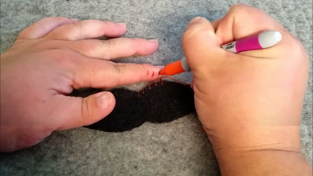making finger with sharpie for even stitches