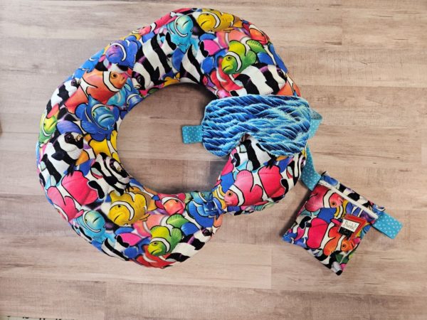 travel neck pillow with brightly colored fish, ocean wave mask and wrist bag