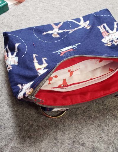 go everywhere pouch - blue with pirates on it. Red inside with zippered pocket