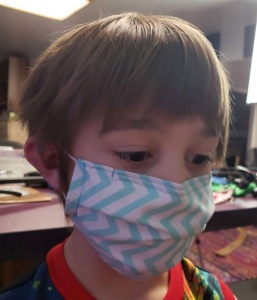 child wearing blue and white chevron face mask