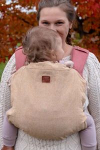 cream linen slipcover on pink onbuhimo carrier with ligh skinned baby and mother.