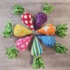 stuffed fabric carrots in purple, red, yellow, pink, blue, orange and stipe arranged in a circle