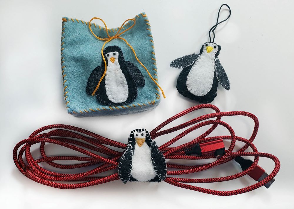 3 penguin felt items, A felt bag, a cord wrap, and an ornament