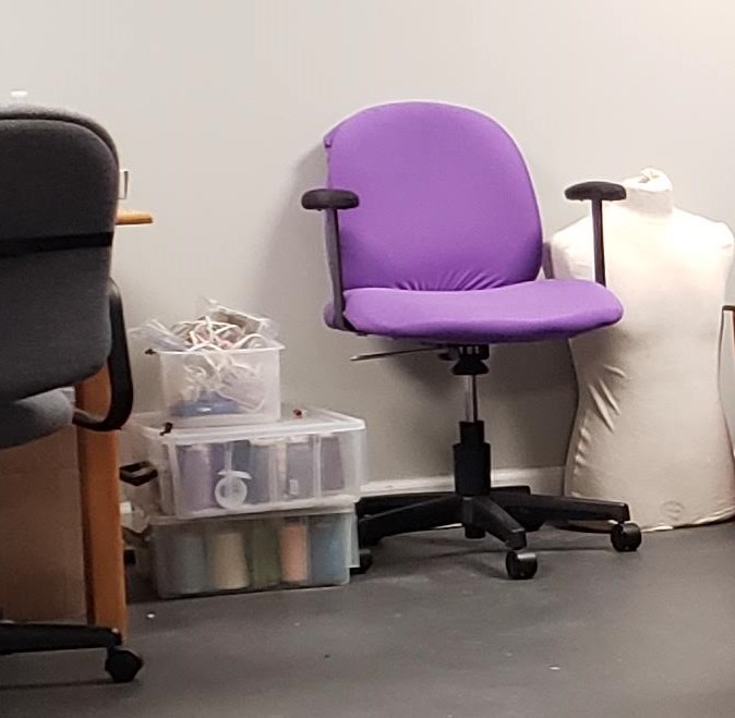 Purple chair next to white dress form torso