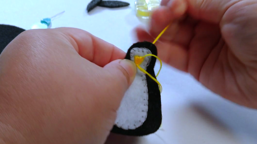 Felt Penguin Ornament sewing on yellow beak