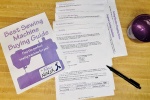 Sewing machine Buying guide workbook pages laid out on a table. Cover has purple sewing machine.