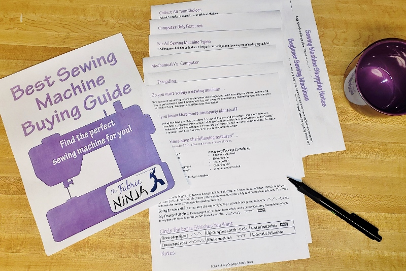 Sewing machine Buying guide workbook pages laid out on a table. Cover has purple sewing machine.