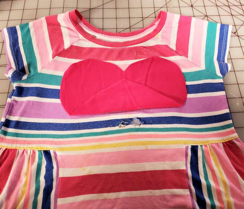 rainbow striped shirt with hole ready to be covered with pink heart