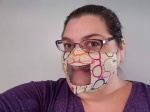 Mask with clear window being worn by white woman with dark hair.