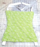 green fabric with small roses made into a sleeping hood with tie straps