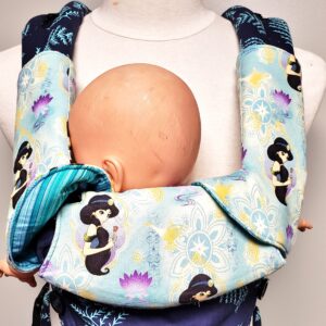 Blue Jasmine suck pads and bib on the Tula Explore Carrier. One corner flipped up to show reverse side.