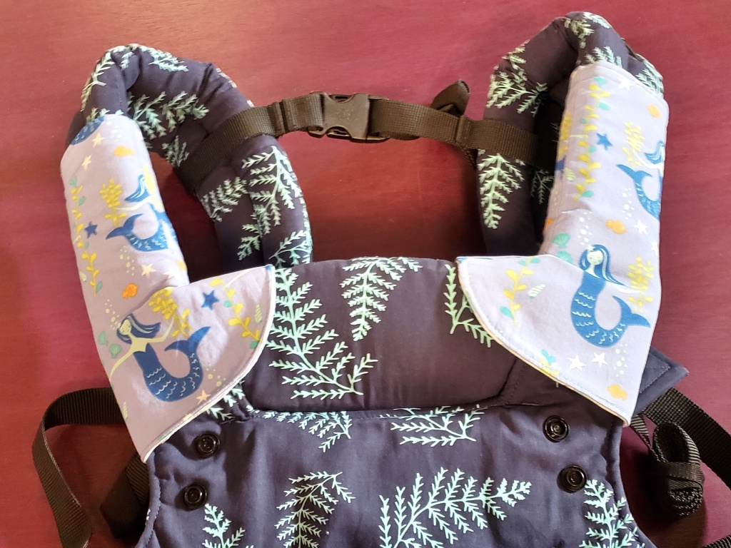 Blue mermaid suck pads on the Tula Explore Carrier