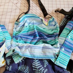 Blue striped hood and suck pad on a Tula explore