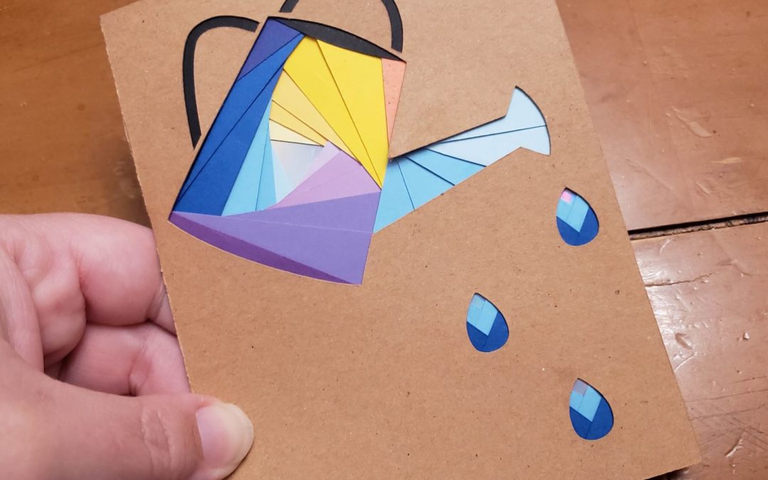 Card with watering can on the front. Can outline is filled with swirled papers that come to a metallic center. Using Iris Paper Folding